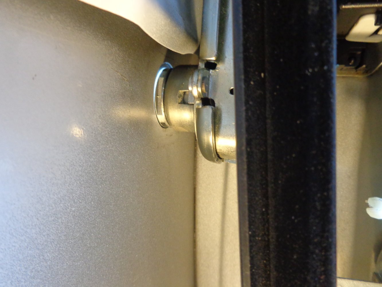 Inside door panel with spring clip removed and PIN visible behind window linkage.JPG