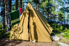 old-canvas-tent-stands-pine-forest-island-drying-clothes-36798528.jpg