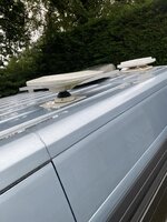 Photo of white TV aerial on a blue campervan roof