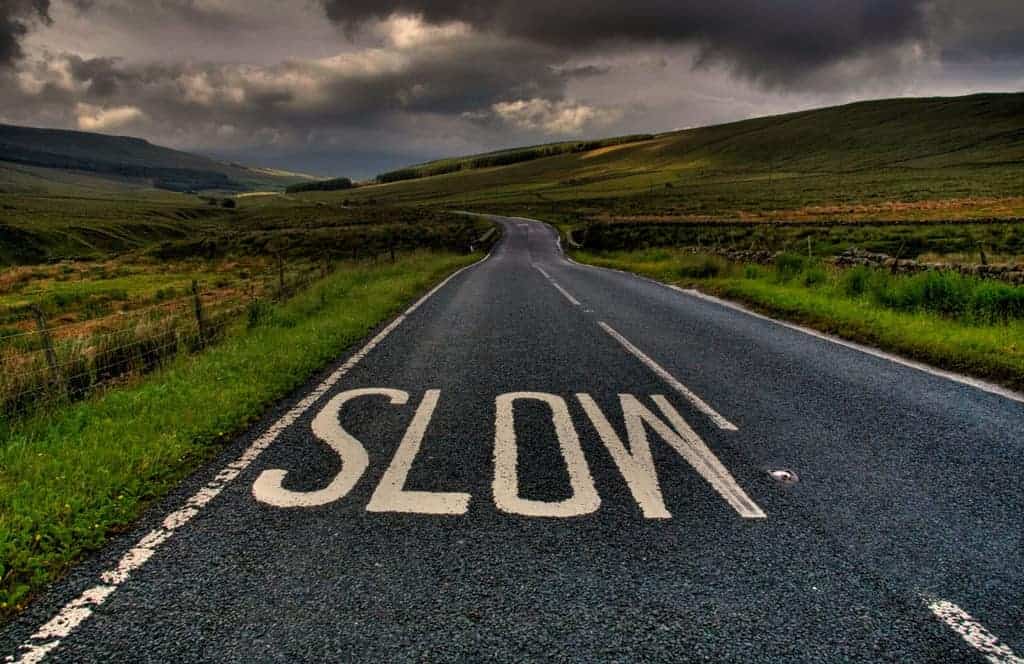 Road-in-Country-with-Slow-Sign.jpg