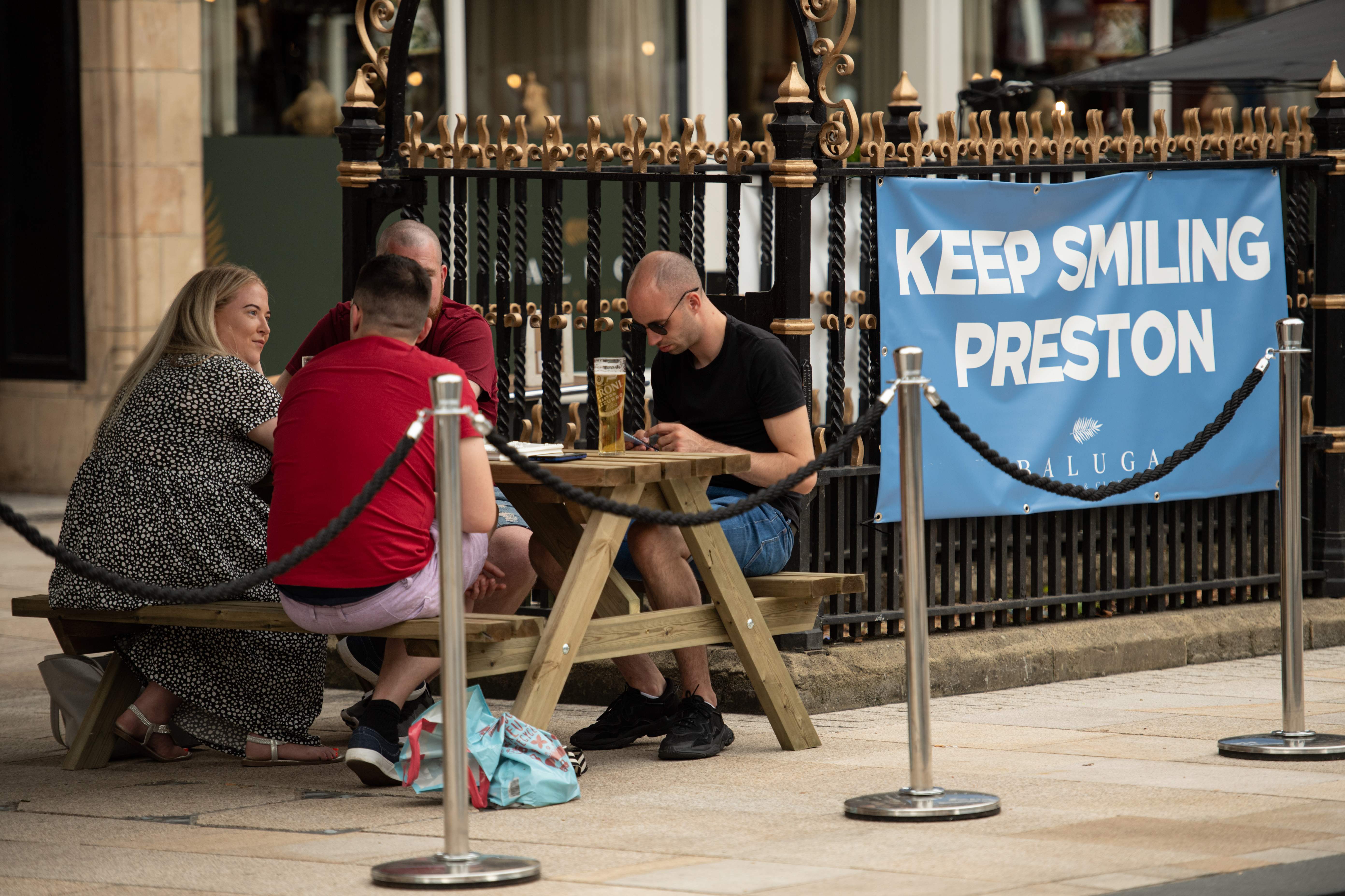 Drinkers at a bar in Preston city centre where tighter restrictions have been put in place